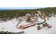 Aerial view of a modern home featuring a barn, pool and large snowy lot at 367 Sandy Hollow Trl, Franktown, CO 80116