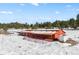 View of barn with snow-covered roof on the property surrounded by snow covered ground at 367 Sandy Hollow Trl, Franktown, CO 80116