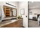 Contemporary bathroom with marble countertop, dark wood cabinets, and decorative mirror at 367 Sandy Hollow Trl, Franktown, CO 80116