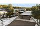 Modern home featuring a two-car garage, porte-cochere, and professional landscaping nestled amongst snow-covered trees at 367 Sandy Hollow Trl, Franktown, CO 80116