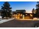 Stunning modern home with sleek architectural lines, a porte-cochere, and a well-lit two-car garage at 367 Sandy Hollow Trl, Franktown, CO 80116