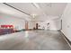 Spacious and well-lit three car garage featuring concrete floors and ample storage space at 367 Sandy Hollow Trl, Franktown, CO 80116