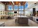 Spacious living area with soaring ceilings, exposed brick, fireplace, and chef's kitchen with island seating at 367 Sandy Hollow Trl, Franktown, CO 80116