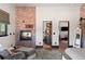 This living room has a brick fireplace, an opening to other rooms, and stylish decor at 367 Sandy Hollow Trl, Franktown, CO 80116