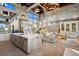 Open-concept living space with modern kitchen and expansive living area with high ceilings and stylish decor at 367 Sandy Hollow Trl, Franktown, CO 80116