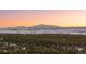 Serene landscape view of Colorado mountains at sunset surrounded by lush tree line at 367 Sandy Hollow Trl, Franktown, CO 80116