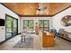 This office has a wood ceiling, built-in shelves, an executive desk, and forest views at 367 Sandy Hollow Trl, Franktown, CO 80116