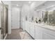 Modern bathroom featuring double sinks, white cabinetry, and a glass-enclosed shower at 15788 Xanthia Way, Thornton, CO 80602