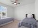 Bright bedroom with two beds, large window, and neutral decor provides a relaxing retreat at 15788 Xanthia Way, Thornton, CO 80602
