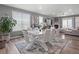 Contemporary dining room with a modern table set, large windows, and an open layout at 15788 Xanthia Way, Thornton, CO 80602