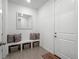 Functional entryway with built-in bench, storage baskets, and a neutral color palette at 15788 Xanthia Way, Thornton, CO 80602