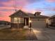 Charming single-Gathering home featuring a two-car garage and manicured front yard at sunset at 15788 Xanthia Way, Thornton, CO 80602