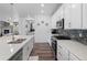 Modern kitchen boasts stainless appliances, quartz countertops, subway tile backsplash, and ample cabinet space at 15788 Xanthia Way, Thornton, CO 80602