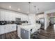 Modern kitchen featuring stainless steel appliances, sleek white cabinetry, and a spacious island at 15788 Xanthia Way, Thornton, CO 80602