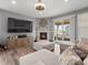 Cozy living room with fireplace, modern decor, and sliding glass doors to outdoor seating area at 15788 Xanthia Way, Thornton, CO 80602