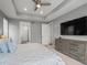 Spacious main bedroom with tray ceilings, a tv, and neutral gray walls at 15788 Xanthia Way, Thornton, CO 80602