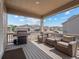 Relaxing covered patio featuring comfortable seating and a grill for outdoor enjoyment at 15788 Xanthia Way, Thornton, CO 80602