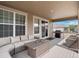 Cozy covered patio with comfortable seating, a grill, and a serene outdoor ambiance at 15788 Xanthia Way, Thornton, CO 80602