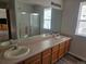 Spacious bathroom featuring double sinks, a large mirror, and a shower-tub combo at 2746 E 132Nd Pl, Thornton, CO 80241