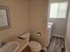 Powder room with a toilet, washing machine, sink, vanity and new vinyl flooring at 2746 E 132Nd Pl, Thornton, CO 80241