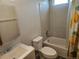 Bathroom with a bathtub, toilet, sink, and a mirror, providing essential amenities at 2746 E 132Nd Pl, Thornton, CO 80241