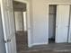 A bright bedroom featuring wood-look floors, neutral walls, and ample closet space at 2746 E 132Nd Pl, Thornton, CO 80241