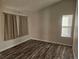 A spacious bedroom with two windows, neutral walls, and wood-look flooring at 2746 E 132Nd Pl, Thornton, CO 80241
