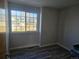 Neutral bedroom featuring hardwood floors and a window showcasing neighborhood views at 2746 E 132Nd Pl, Thornton, CO 80241