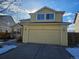 Two-story yellow home featuring an attached two-car garage and well-maintained lawn at 2746 E 132Nd Pl, Thornton, CO 80241