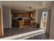 Open-concept kitchen boasts wood cabinets, an island, and access to the deck at 2746 E 132Nd Pl, Thornton, CO 80241