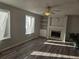 Bright living room includes fireplace, ceiling fan, and large windows for plenty of light at 2746 E 132Nd Pl, Thornton, CO 80241