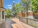 Spacious wooden deck with brown railings overlooking the backyard at 7659 Lebrun Ct, Lone Tree, CO 80124
