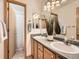 Bathroom featuring a double sink vanity with a tile countertop and shower/tub combo at 7659 Lebrun Ct, Lone Tree, CO 80124