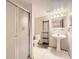 Bright bathroom with a glass-enclosed shower, pedestal sink, and modern fixtures at 7659 Lebrun Ct, Lone Tree, CO 80124