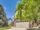 Home exterior featuring a garage, brick accents, and well-manicured lawn at 7659 Lebrun Ct, Lone Tree, CO 80124