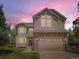 Charming two-story home with a well-manicured lawn and a two-car garage showcasing great curb appeal at 7659 Lebrun Ct, Lone Tree, CO 80124