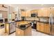 Well-equipped kitchen featuring granite countertops, stainless steel appliances, and custom cabinetry at 7659 Lebrun Ct, Lone Tree, CO 80124