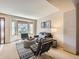 Comfortable living room with stylish seating, a decorative rug, and a large bay window for ample natural light at 7659 Lebrun Ct, Lone Tree, CO 80124