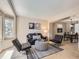 Cozy living room featuring modern furniture, neutral tones, and an abundance of natural light at 7659 Lebrun Ct, Lone Tree, CO 80124