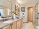 Main bathroom with double vanity and separate glass shower at 7659 Lebrun Ct, Lone Tree, CO 80124
