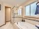 Relaxing soaking tub with separate shower enclosure at 7659 Lebrun Ct, Lone Tree, CO 80124