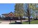 Park building with a covered patio and grassy area and lush trees at 7659 Lebrun Ct, Lone Tree, CO 80124
