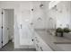Modern bathroom with double vanity, gray countertops, herringbone floors, and glass enclosed shower at 1322 Raleigh St, Denver, CO 80204
