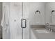 Sleek bathroom featuring a glass-enclosed shower with white marble tiling and modern fixtures at 1322 Raleigh St, Denver, CO 80204