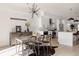 This open dining room is bright, featuring a modern chandelier and view of the kitchen at 1322 Raleigh St, Denver, CO 80204