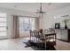 Bright dining room features hardwood floors, modern chandelier, and an oversized window at 1322 Raleigh St, Denver, CO 80204