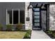Modern home exterior showcasing a stylish front door, stone accents, and neatly landscaped yard at 1322 Raleigh St, Denver, CO 80204