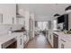 Stylish kitchen with white cabinets, stainless steel appliances, a large island with seating, and hardwood floors at 1322 Raleigh St, Denver, CO 80204