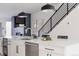 Kitchen island featuring seating, stainless steel dishwasher, and modern pendant lighting above at 1322 Raleigh St, Denver, CO 80204