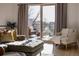 Bright living room featuring hardwood floors, a comfortable seating arrangement, and a sliding glass door to the balcony at 1322 Raleigh St, Denver, CO 80204